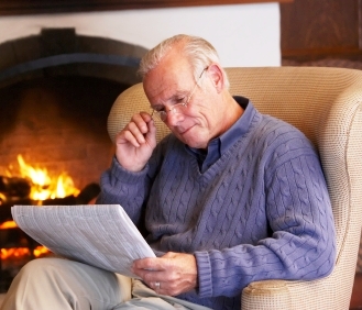 Elderly man sitting in front of the fire in his Buckhead Georgia home