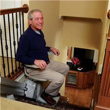 Man riding in stair lift in north Georgia home