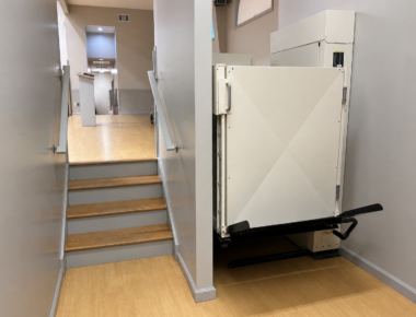 Vertical platform lift installed in a church adjacent to the pulpit platform.